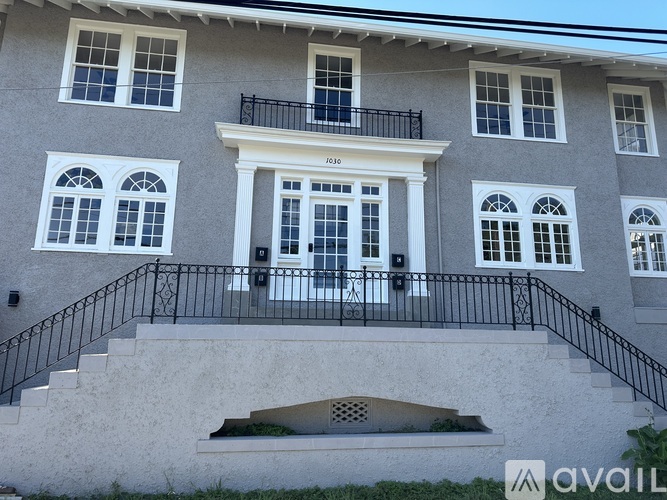 A two-story house with a balcony on the second floor.