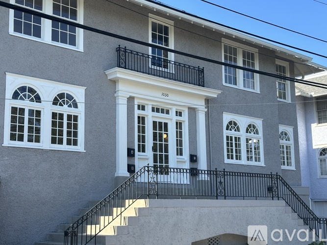 A two-story house with a balcony on the second floor.