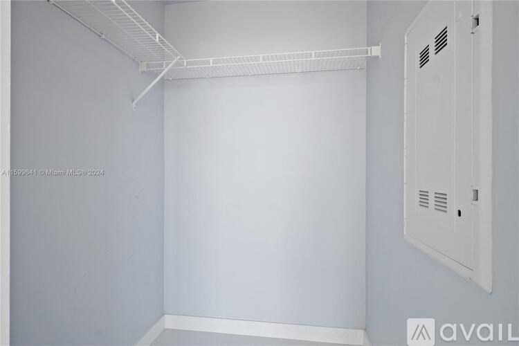 A white room with a white cabinet on the wall.