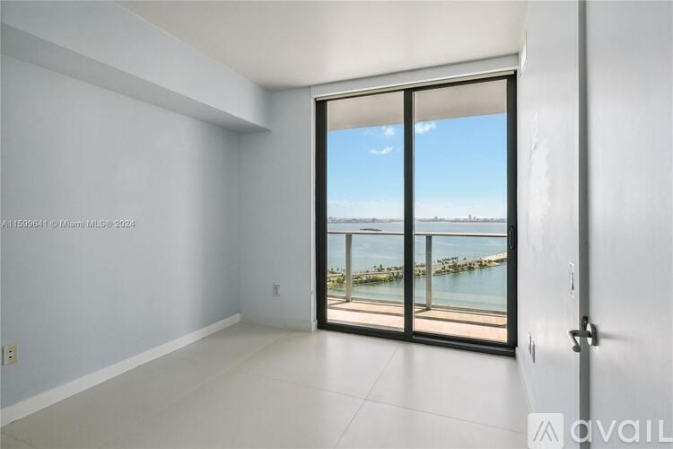 A room with a view of a waterfront area.