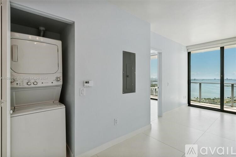 A white wall with a switchboard and a window.