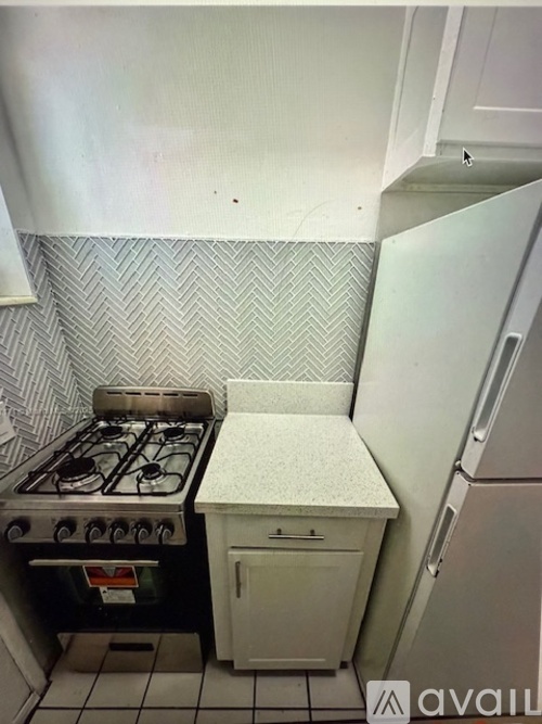 A kitchen with a white fridge and a white door.