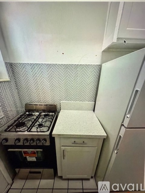 A kitchen with a white fridge and a white door.