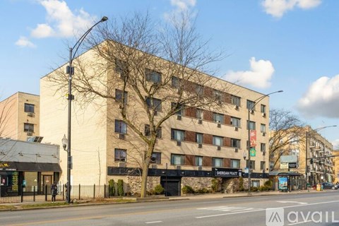 A tall building with a black fence in front of it.