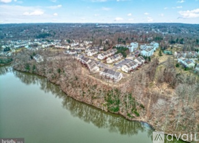 A bird's eye view of a residential area with houses and a river.