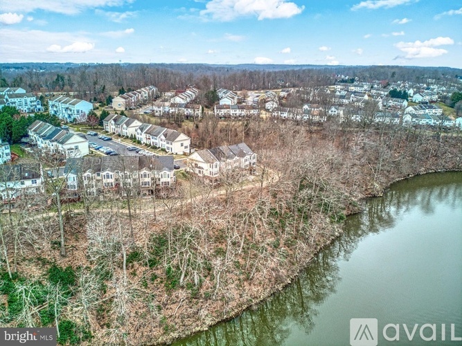 A bird's eye view of a residential area with houses and a river.