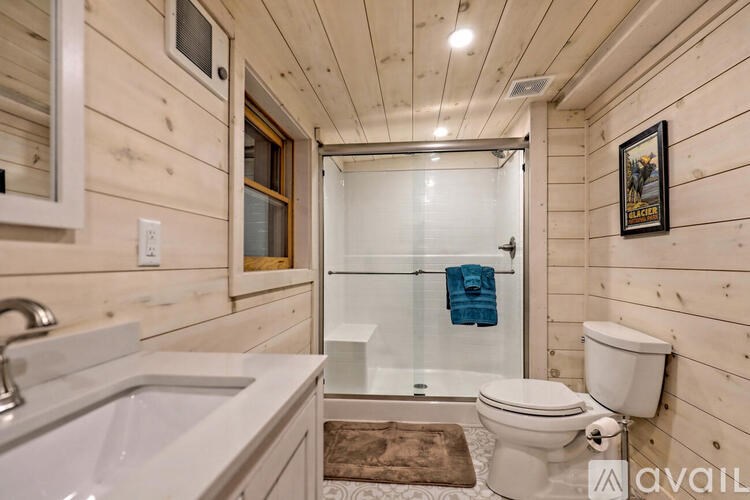 A bathroom with a toilet, sink, and shower.