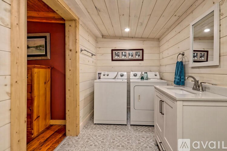 A small bathroom with a washer and dryer built into the cabinetry.