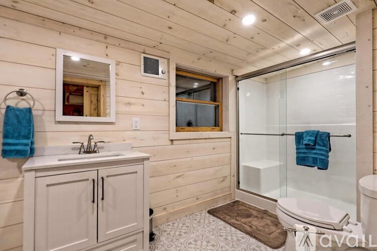A bathroom with a white sink and a mirror above it.