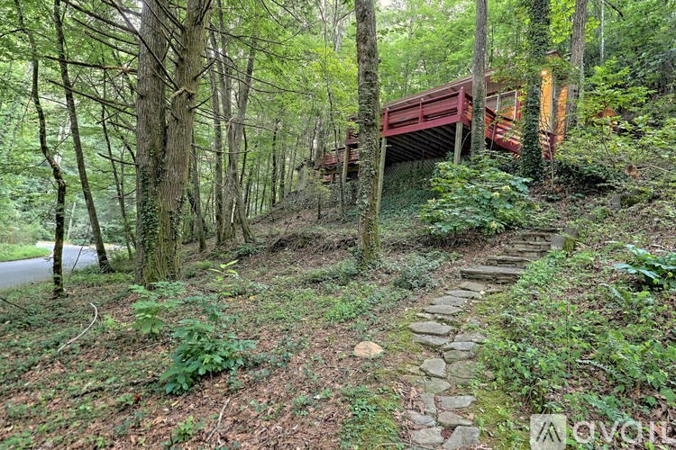 A red wooden bridge in a forest.