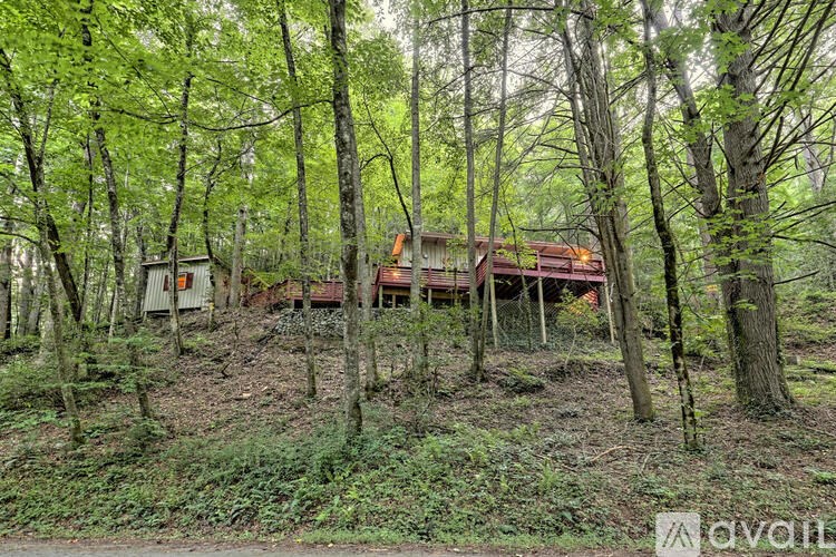 A house is surrounded by trees in a wooded area.