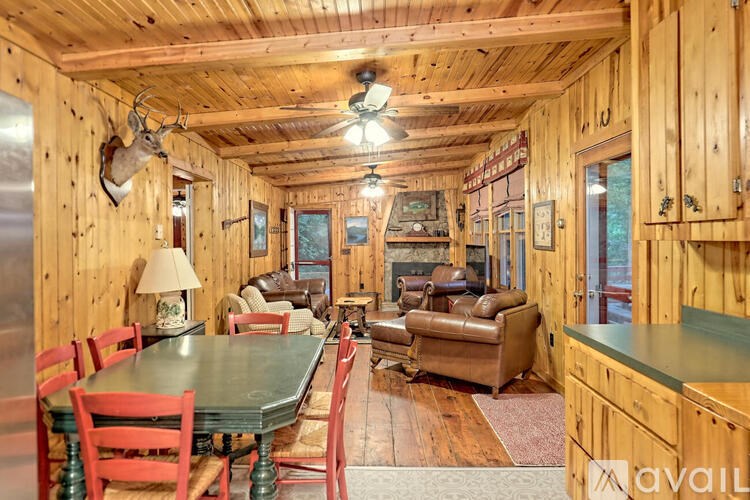 A wooden cabin with a table and chairs.