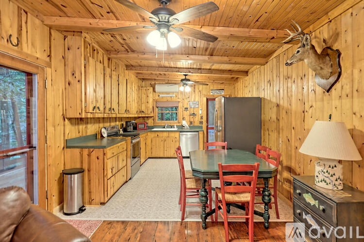A wood-paneled room with a table and chairs.