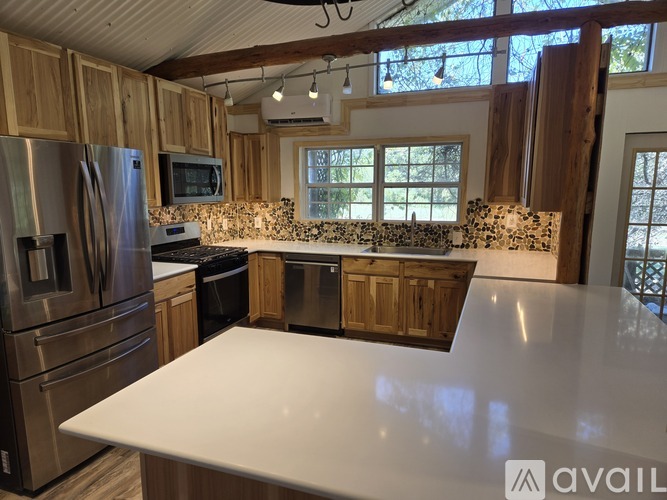 A kitchen with wooden cabinets and stainless steel appliances.