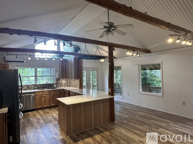 A room with wooden walls and a stone fireplace.