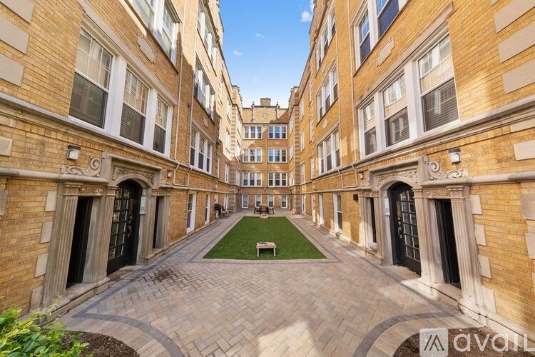 A long, narrow courtyard between two rows of buildings with arched doorways.