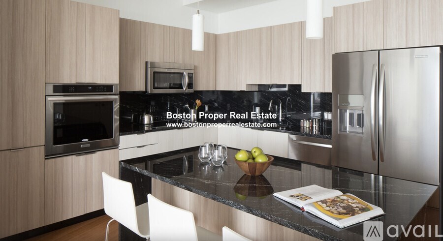 A modern kitchen with wooden cabinets and stainless steel appliances.