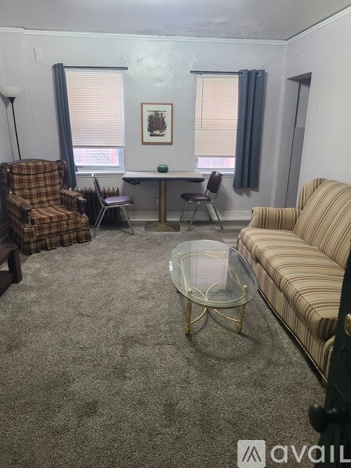 A living room with a sofa, chair, and coffee table.