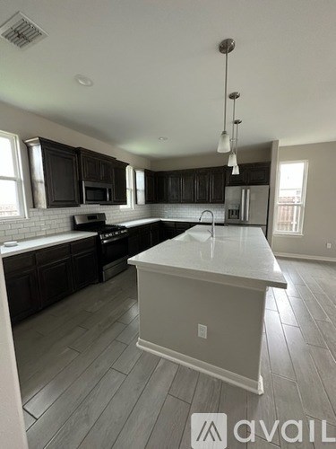 A kitchen with a large island in the middle.