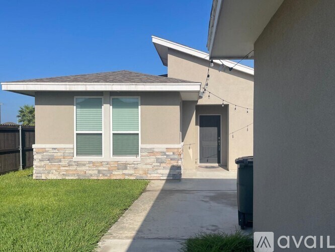 A house with a stone pillar in front of it.