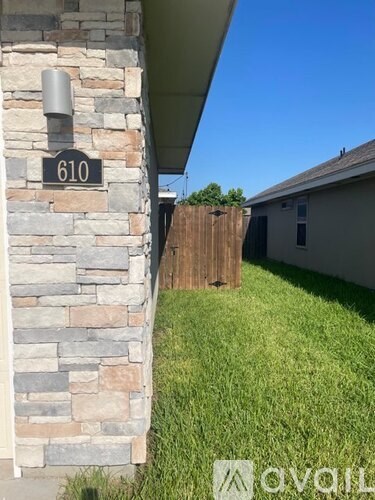 A house numbered 610 is shown with a grassy area in front.