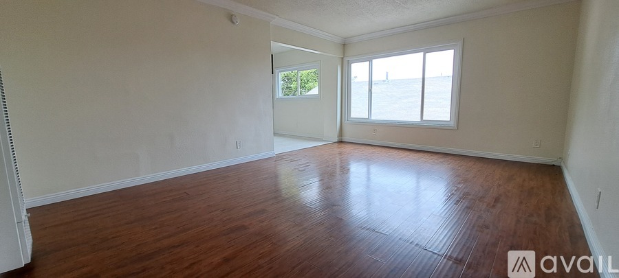 A room with wooden floors and a window.