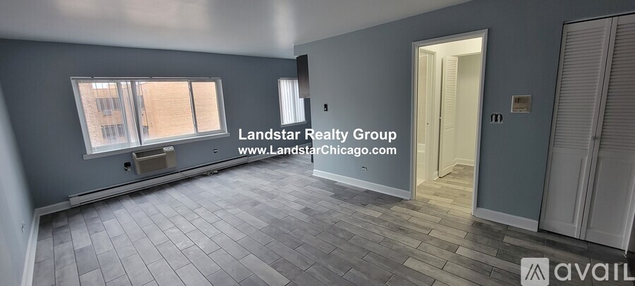 A room with a window and a door is available for rent.