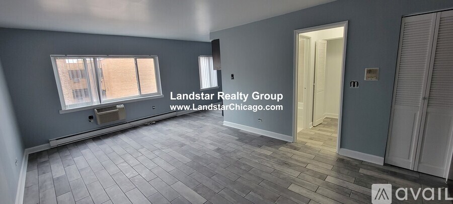 A room with a window and a door is available for rent.