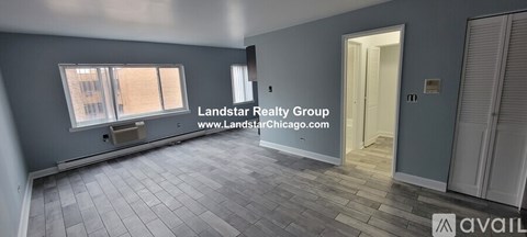 A room with a window and a door is available for rent.