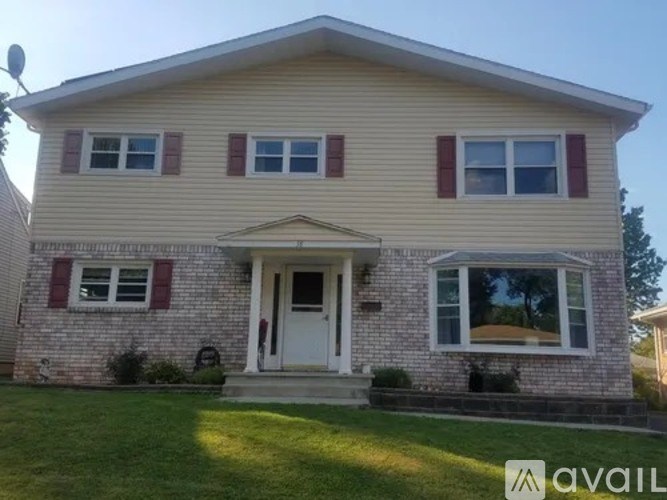 A house with a beige siding and red shutters.