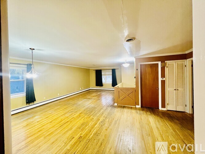 A room with wooden floors and a large window.