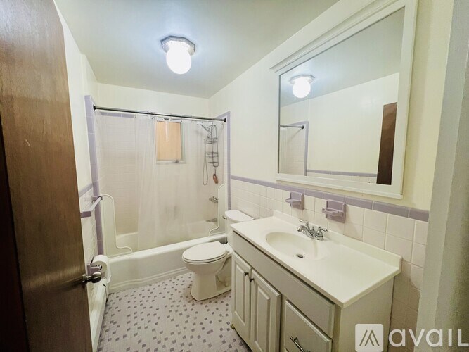 A bathroom with a toilet, sink, and shower.