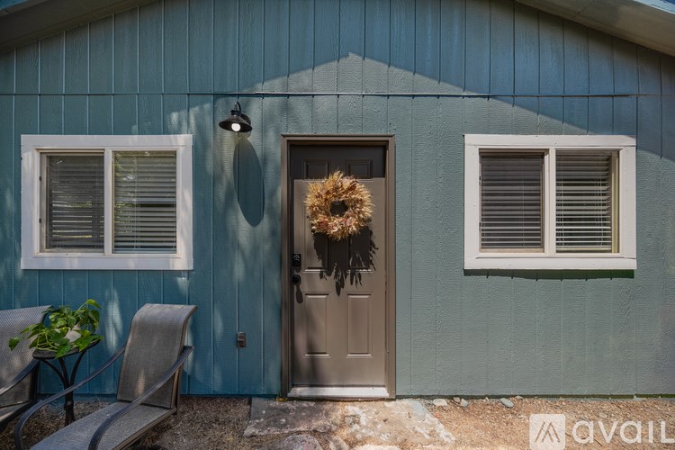 A house with a brown door and a wreath on it.