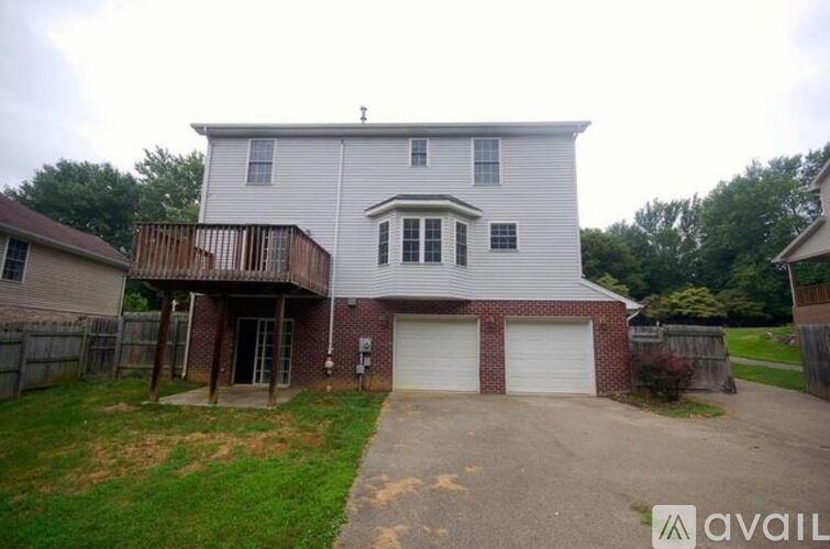 A two-story house with a garage is available for sale.