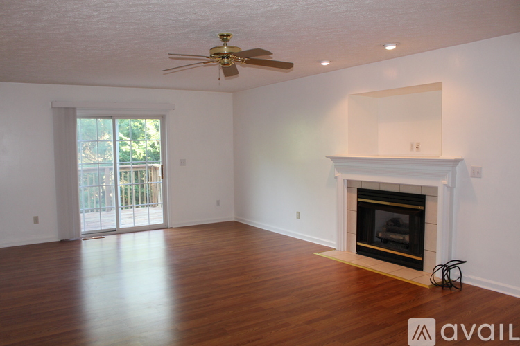 A living room with a fireplace and sliding glass doors.
