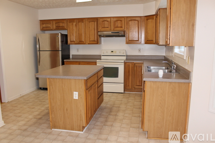 A kitchen with wooden cabinets and stainless steel appliances.