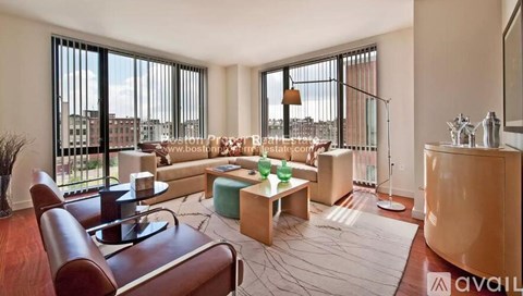 A living room with a brown leather chair and a wooden coffee table.