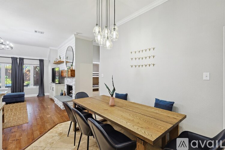 A dining room with a wooden table and chairs.