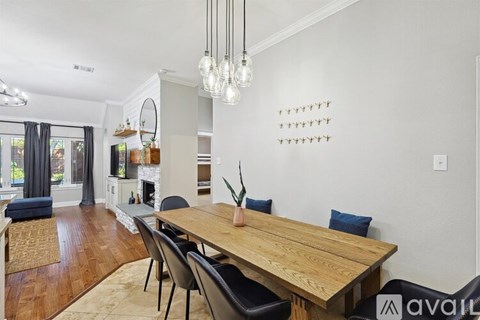 A dining room with a wooden table and chairs.