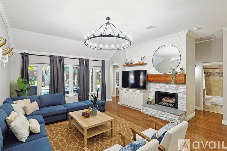 A living room with a blue couch and a wooden coffee table.