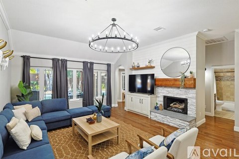 A living room with a blue couch and a wooden coffee table.
