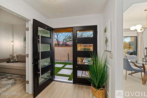 A modern interior with a glass door leading to a balcony.