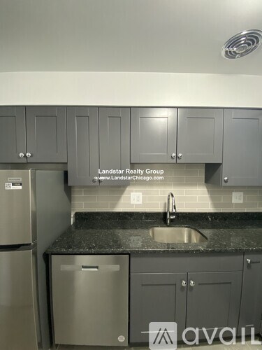 A kitchen with Landstar Realty Group logo on the wall.