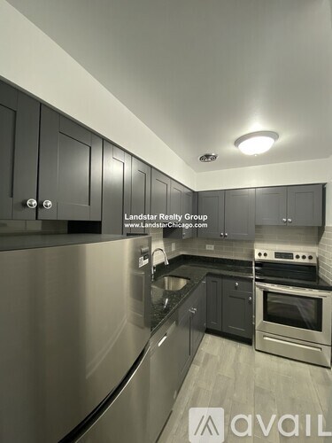 A modern kitchen with Landstar Realty Group logo on the wall.