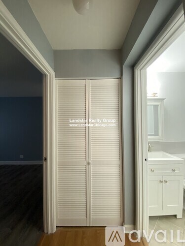 Closed white blinds in a room with a wooden floor.