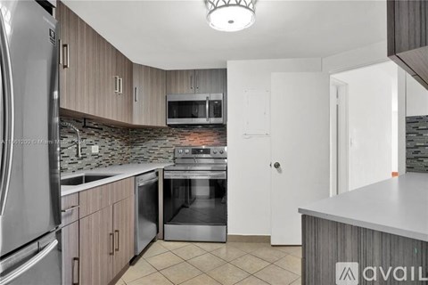 A kitchen with a stainless steel refrigerator and a dishwasher.