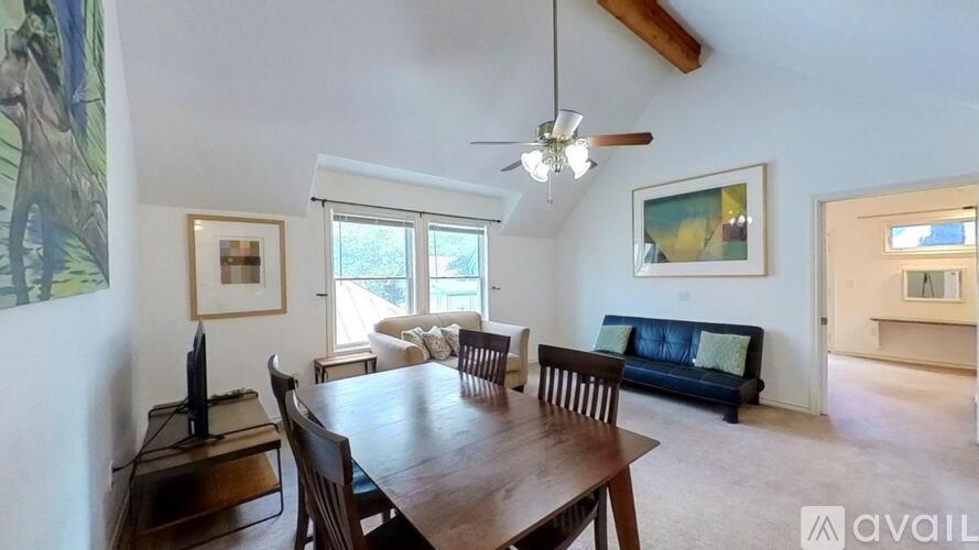 A dining room with a wooden table and chairs.