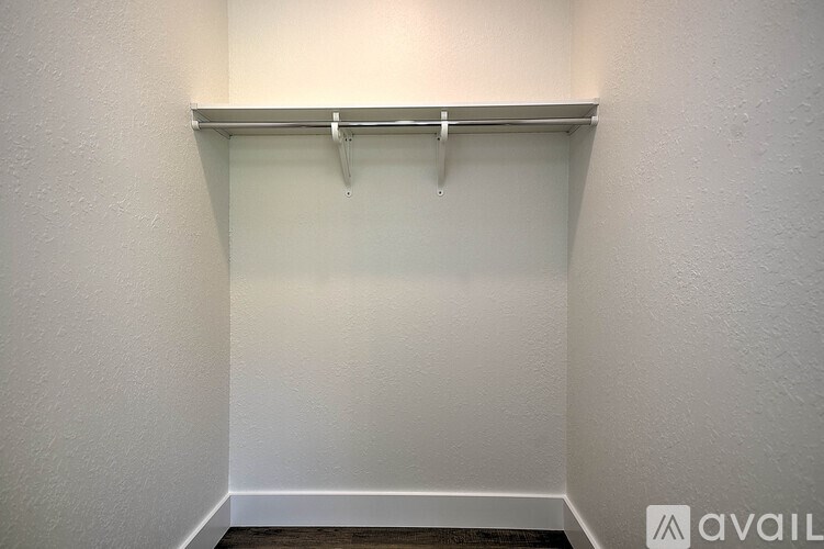 A white wall with a coat rack mounted on it.