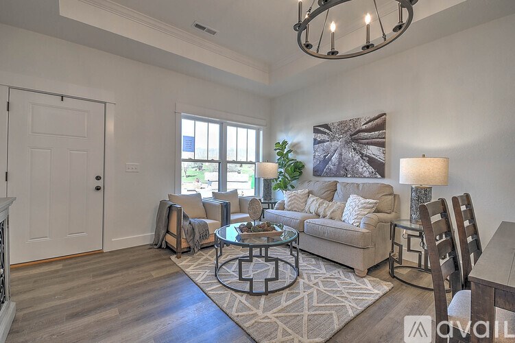 A living room with a couch, chairs, and a coffee table.