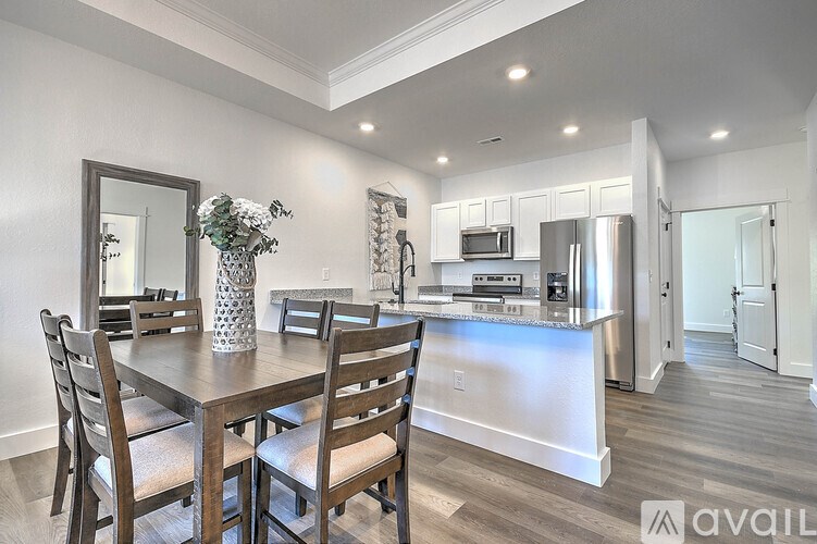 A dining room with a wooden table and chairs.